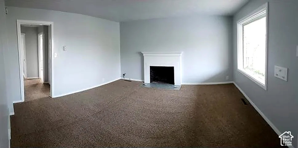 Upper unit living room with fireplace.