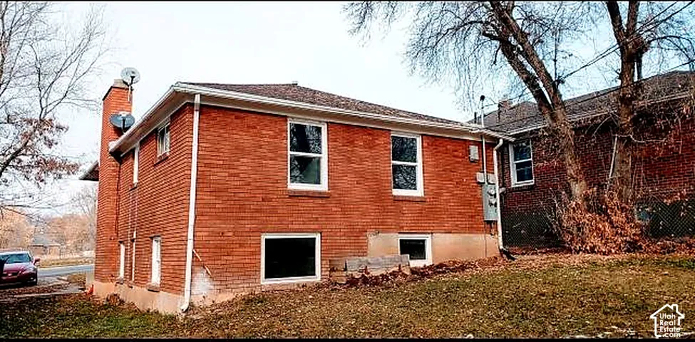 Side and rear elevation. All-brick construction with separate utility meters.