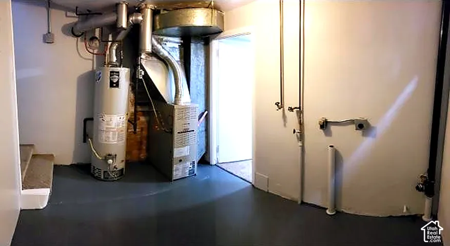 Mechanical room with furnace and water heater.