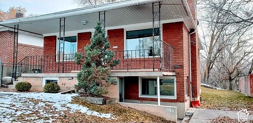 All-brick up and down duplex with covered entry porches for both units.