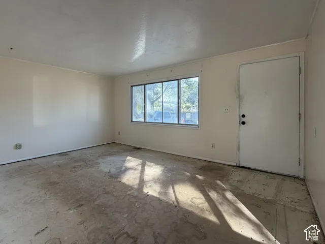 Interior space featuring large multi-pane window and entry door