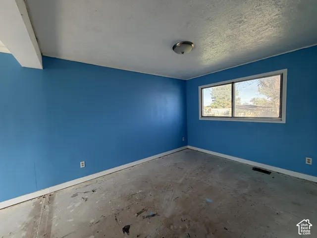 Interior room featuring smooth-finished walls and a horizontal sliding window with a white frame