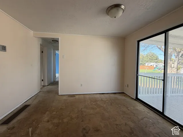 Large sliding glass door with access to an exterior deck and a ceiling-mounted dome light fixture