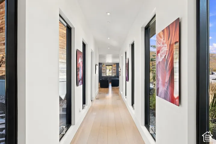 Main hallway with it's floor to ceiling windows functions as an art gallery on your way to the west wing of the home.