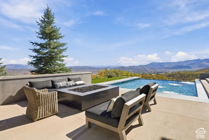 Beautiful private patio with custom infinity-edge pool, fire place, and views of the Uinta Range, Deer Valley, Park City and Wasatch Back