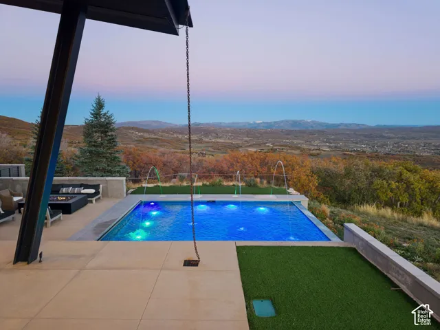 Beautiful private patio with custom infinity-edge pool, fire place, and views of the Uinta Range, Deer Valley, Park City and Wasatch Back