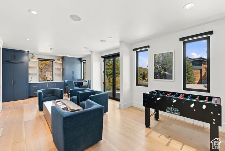 West wing of home featuring wetbar, game room, access to multiple patios and all three multi-level bedrooms