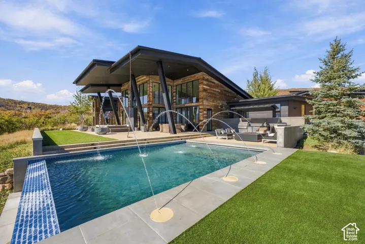 Beautiful private patio with custom infinity-edge pool, fire place, and views of the Uinta Range, Deer Valley, Park City and Wasatch Back