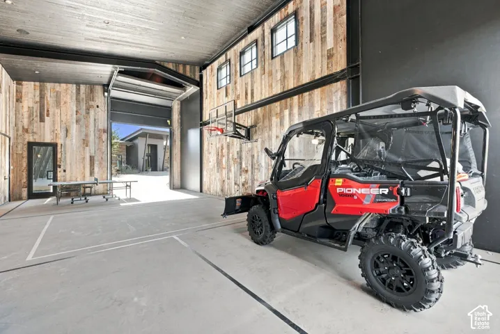 Detached recreation barn (41' x 32') provides indoor pickleball and basketball courts. Oversized drive through roll-up doors provide convenient RV or boat storage. Upper and lower storage areas for all your outdoor equipment
