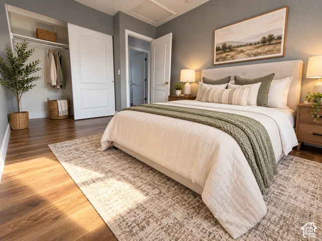 Wood-finish flooring, neutral wall tones, multi-panel interior doors, and a built-in closet with an overhead shelving rack