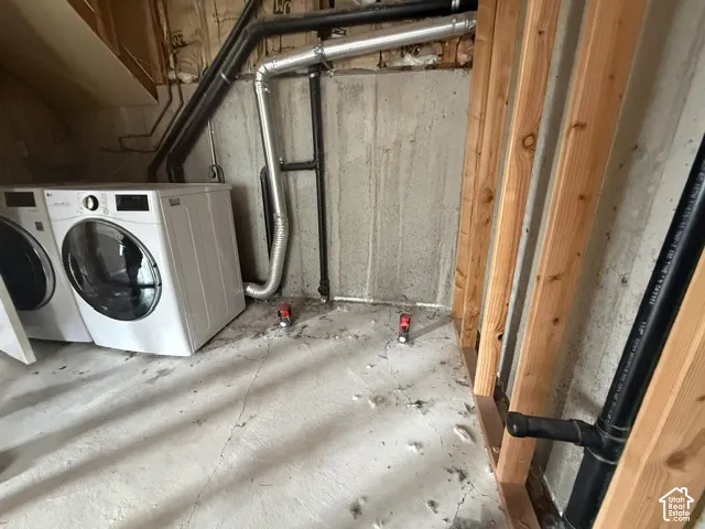 Concrete foundation walls, exposed wood framing, and exposed utility piping