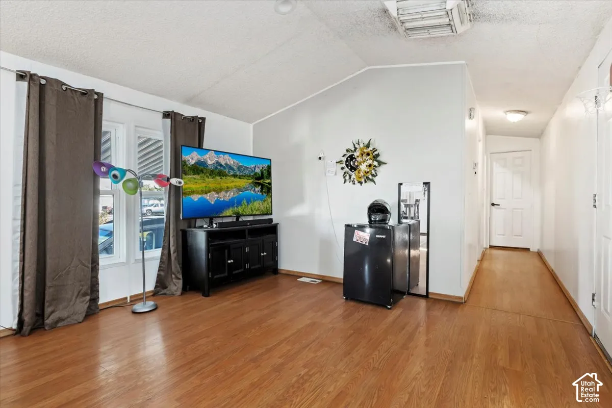 Vaulted ceilings, wood-finish flooring, and double-pane windows with multi-panel interior doors