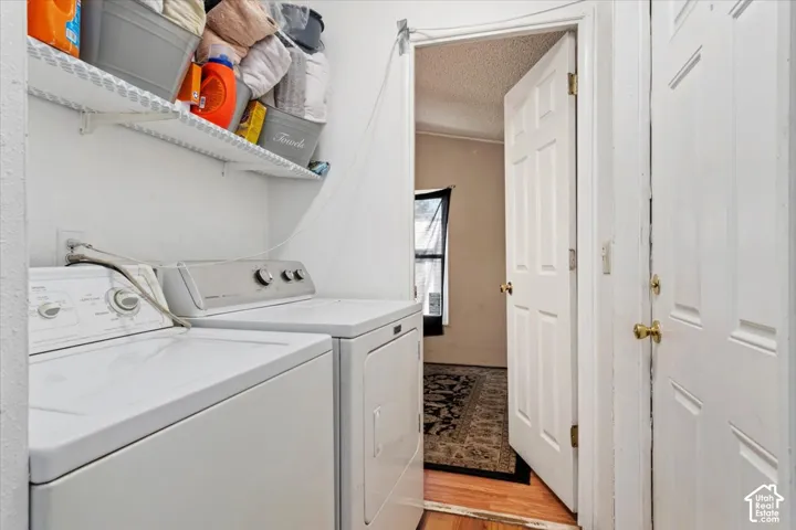 Dedicated laundry area featuring wall-mounted open wire shelving and a six-panel interior door