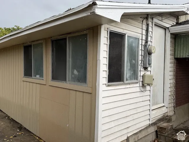 Exterior featuring vertical wood-composite siding, horizontal lap siding, and sliding-glass windows