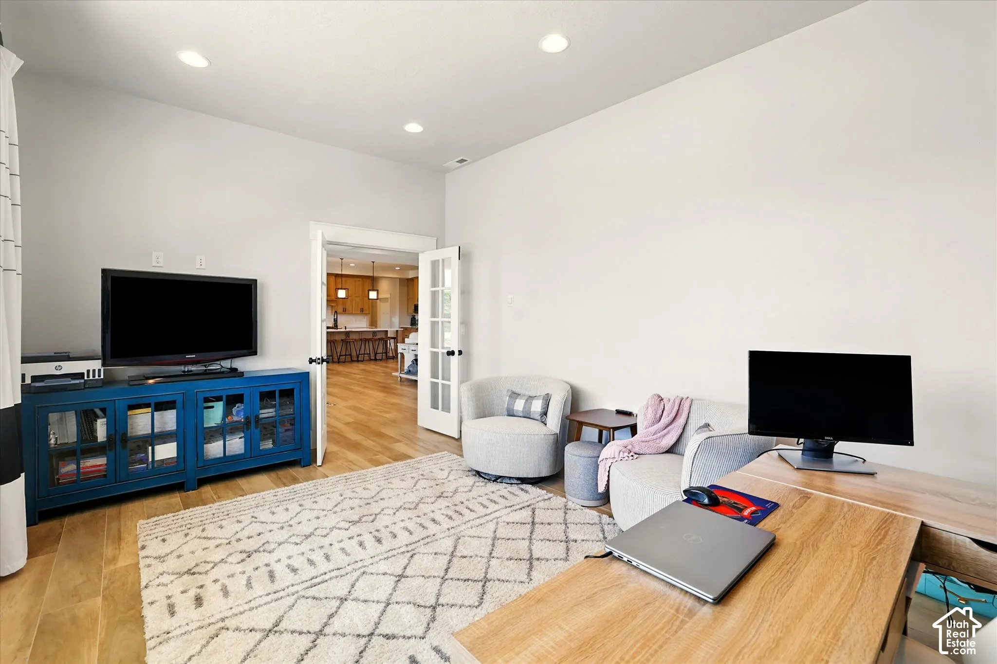 Office/Den with wood-finish flooring, recessed lighting, and white-paneled French doors