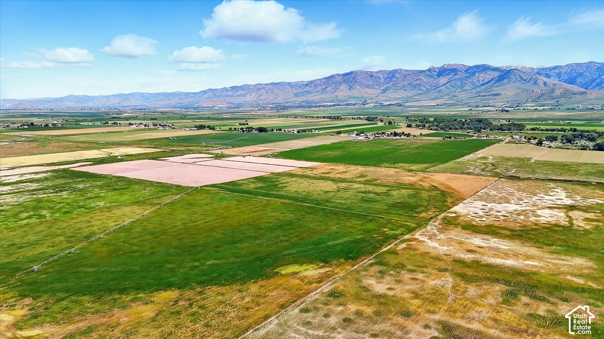 Expansive acreage featuring open fields, agricultural land, and mountain backdrops