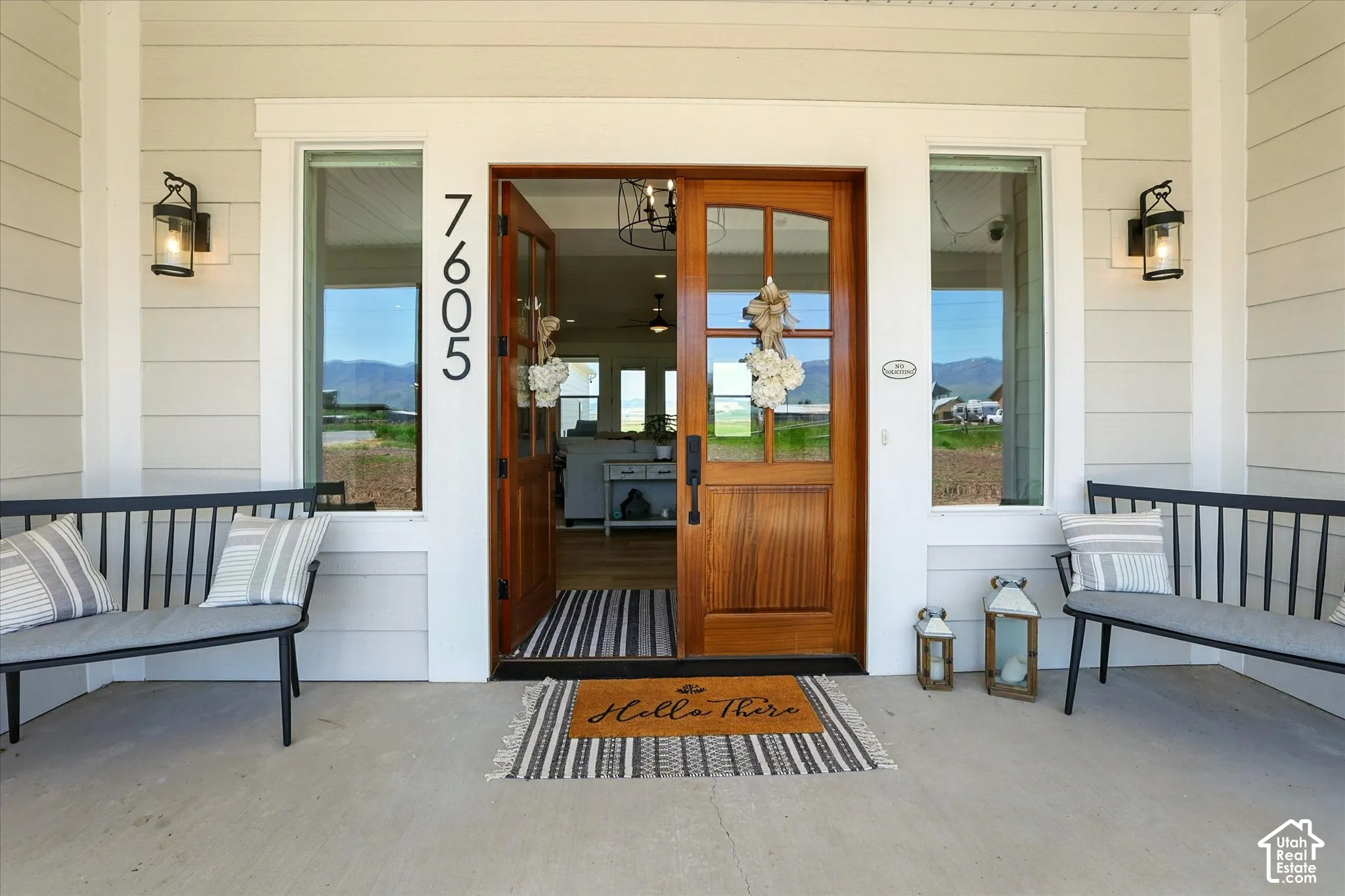 Covered entry with 8 foot custom hardwood double doors.