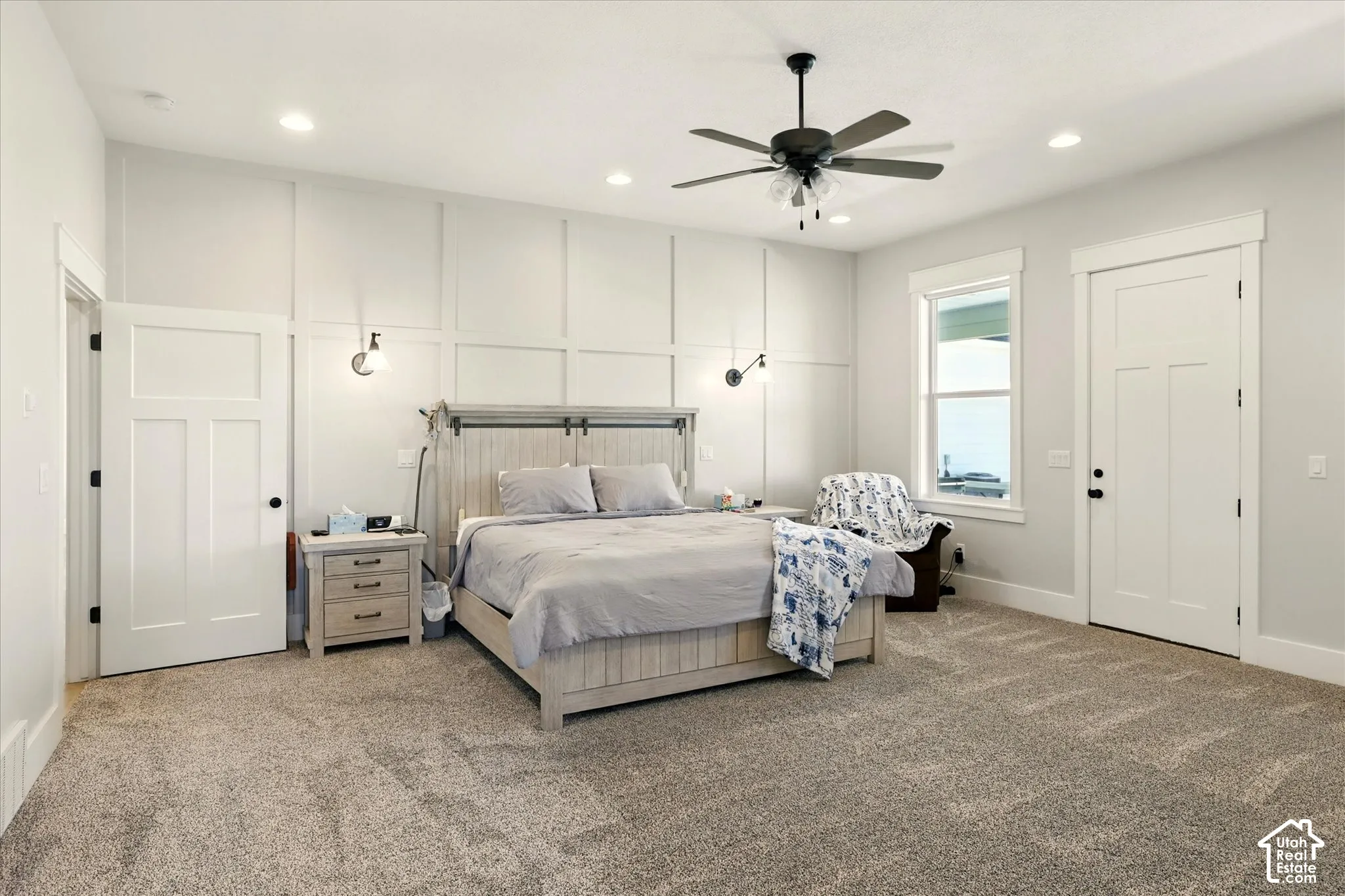 Primary Bedroom featuring wall paneling, recessed lighting, ceiling fan, wall-mounted light fixtures, and multi-panel interior doors