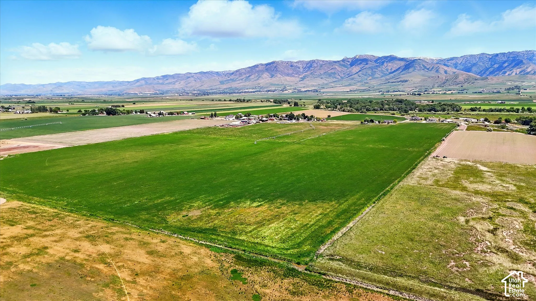 Expansive acreage featuring open fields, agricultural land, and prominent mountain backdrops