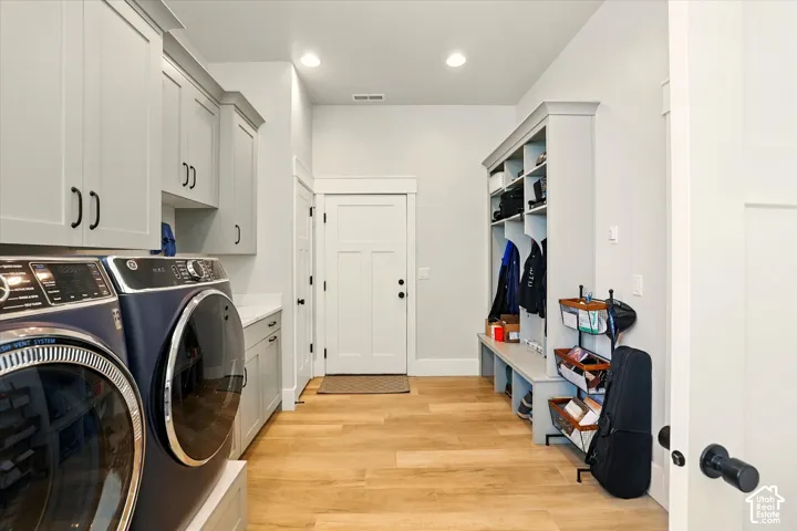 Laundry room featuring light grey cabinetry, solid surface countertops, recessed lighting, built-in mudroom lockers, and wood-finish flooring