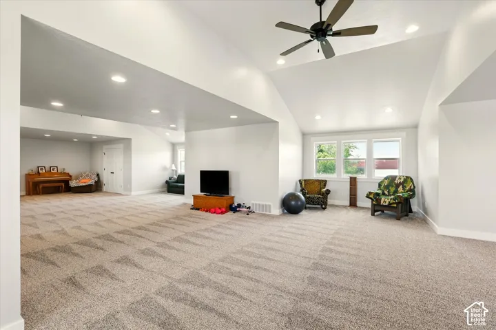 Spacious bonus room featuring vaulted ceilings, recessed lighting, wall-to-wall carpeting, and a ceiling fan