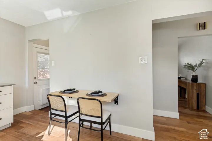 Wall-mounted natural wood surface, wood-finish flooring, and crisp neutral wall paint