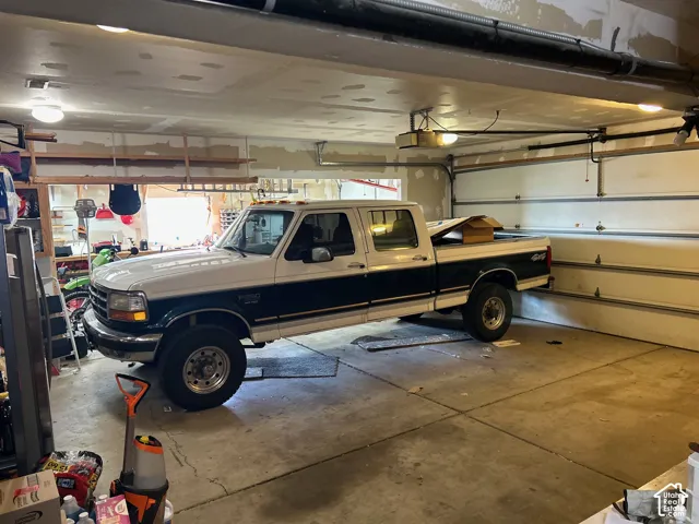 Attached 3 car garage third bay has a drive-through overhead door.