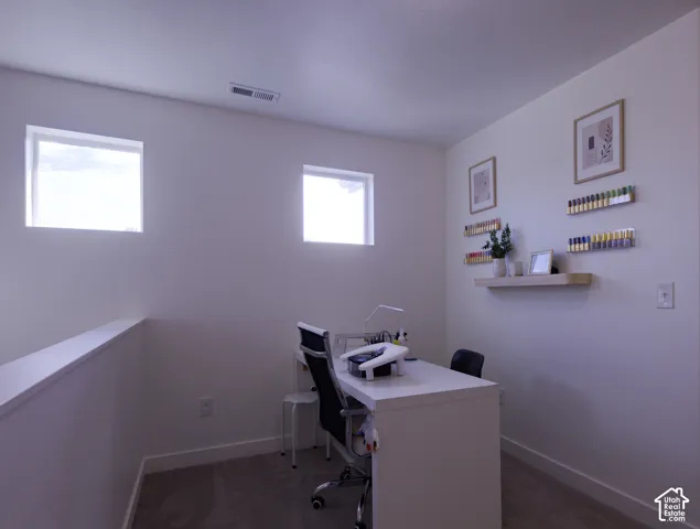 Loft Neutral interior space featuring high-placed square windows, wall-to-wall carpeting, and a built-in floating wooden shelf