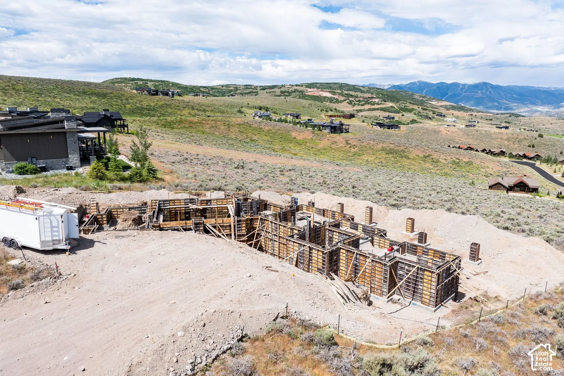 Expansive lot featuring concrete foundation forms and mountain backdrop