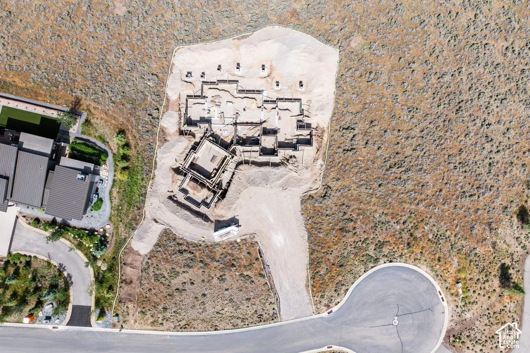 Aerial perspective of a building foundation on a sizable lot with direct cul-de-sac access