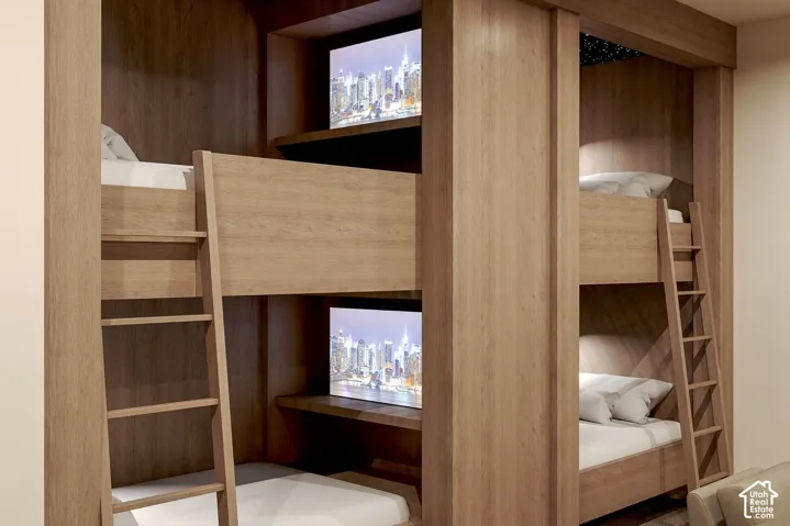 Custom built-in wood-finish bunk configuration with integrated shelving, dedicated recessed displays, and vertical access ladders