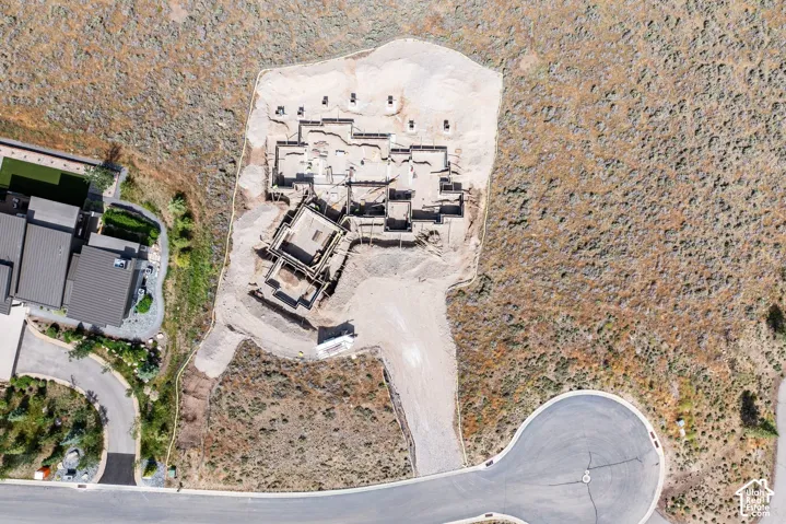 Aerial perspective of a building foundation on a sizable lot with direct cul-de-sac access