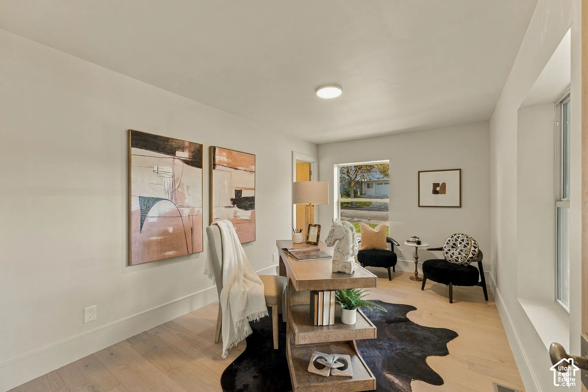 Neutral walls, light-toned wood-finish flooring, and recessed ceiling lighting