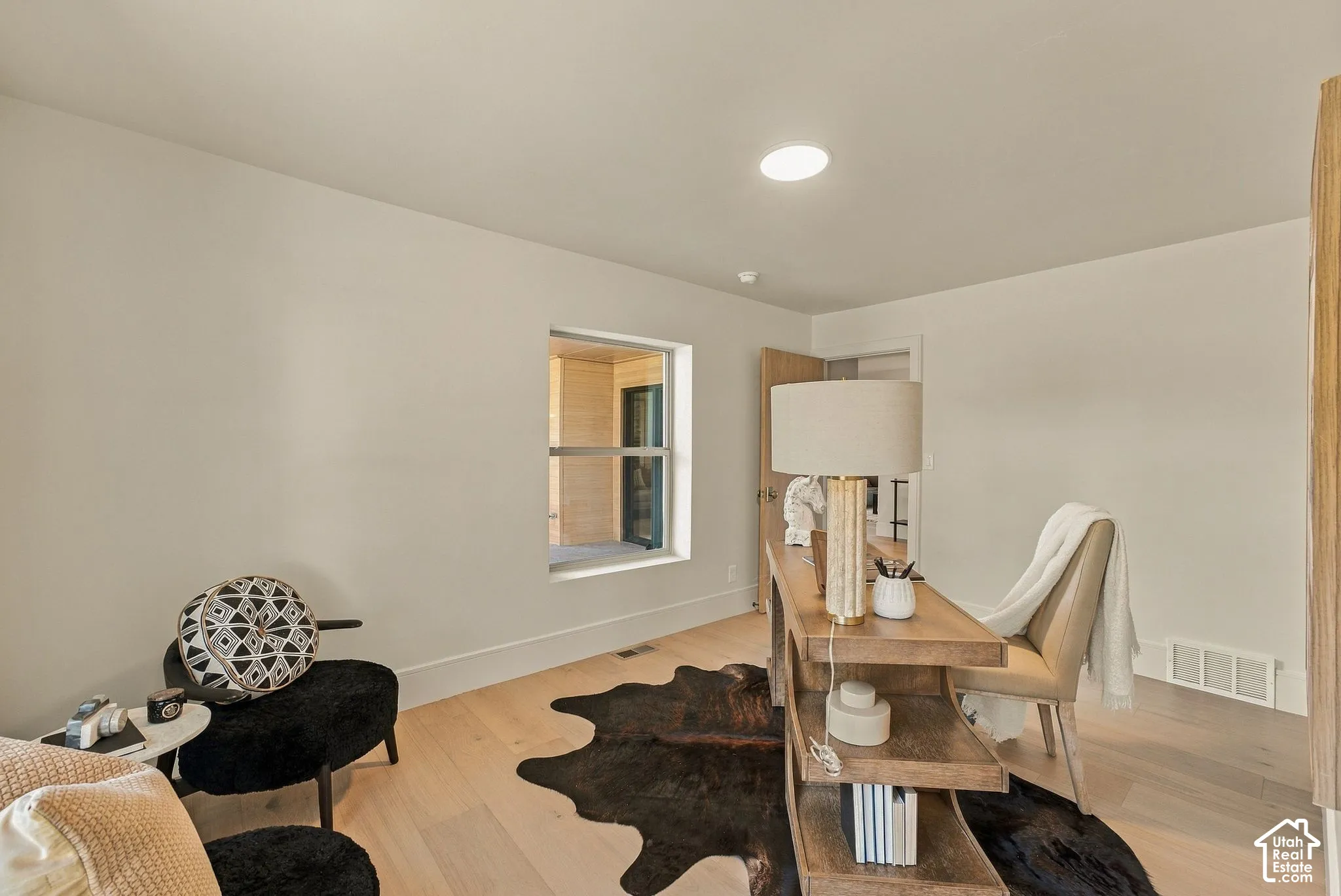 Interior space featuring light-toned wood-finish flooring, neutral wall tones, and recessed lighting