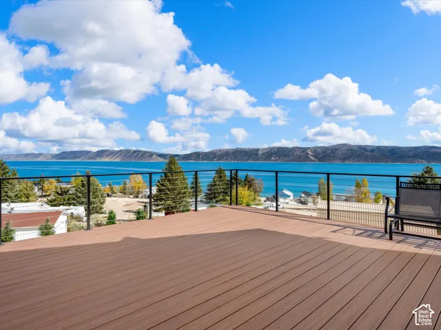 Expansive deck featuring composite decking and a cable railing system overlooking water and mountain scenery