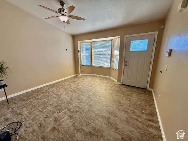 Ceramic tile flooring, bay window, and a ceiling fan with integrated lighting