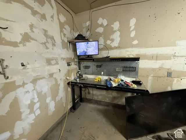 Built-in metal workbench featuring a diamond-plate backboard and integrated shelving