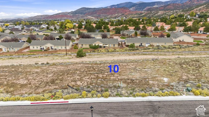 Vacant parcel featuring native desert landscaping, direct paved road access, and mountain backdrop