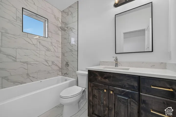 Bathroom featuring dark wood-finish cabinetry, a stone-composite countertop with an integrated basin, a floor-to-ceiling tile shower surround with a built-in window, and a modern square-framed wall mirror