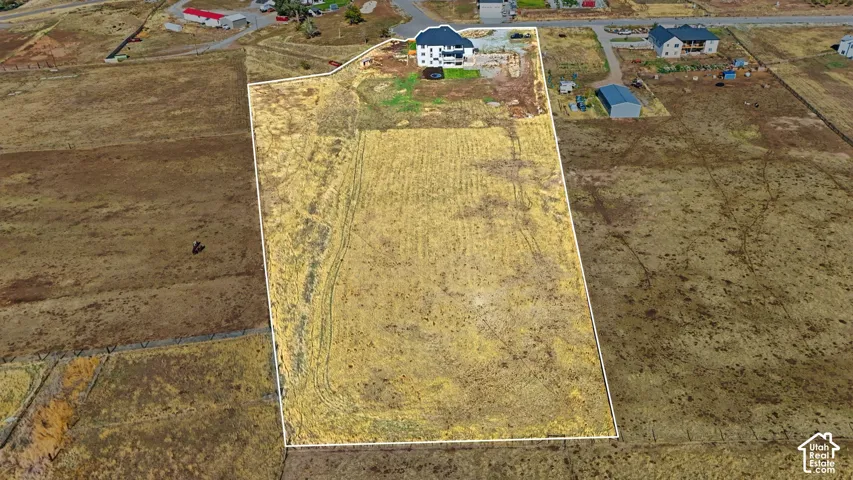 Expansive lot featuring significant open acreage with established road access