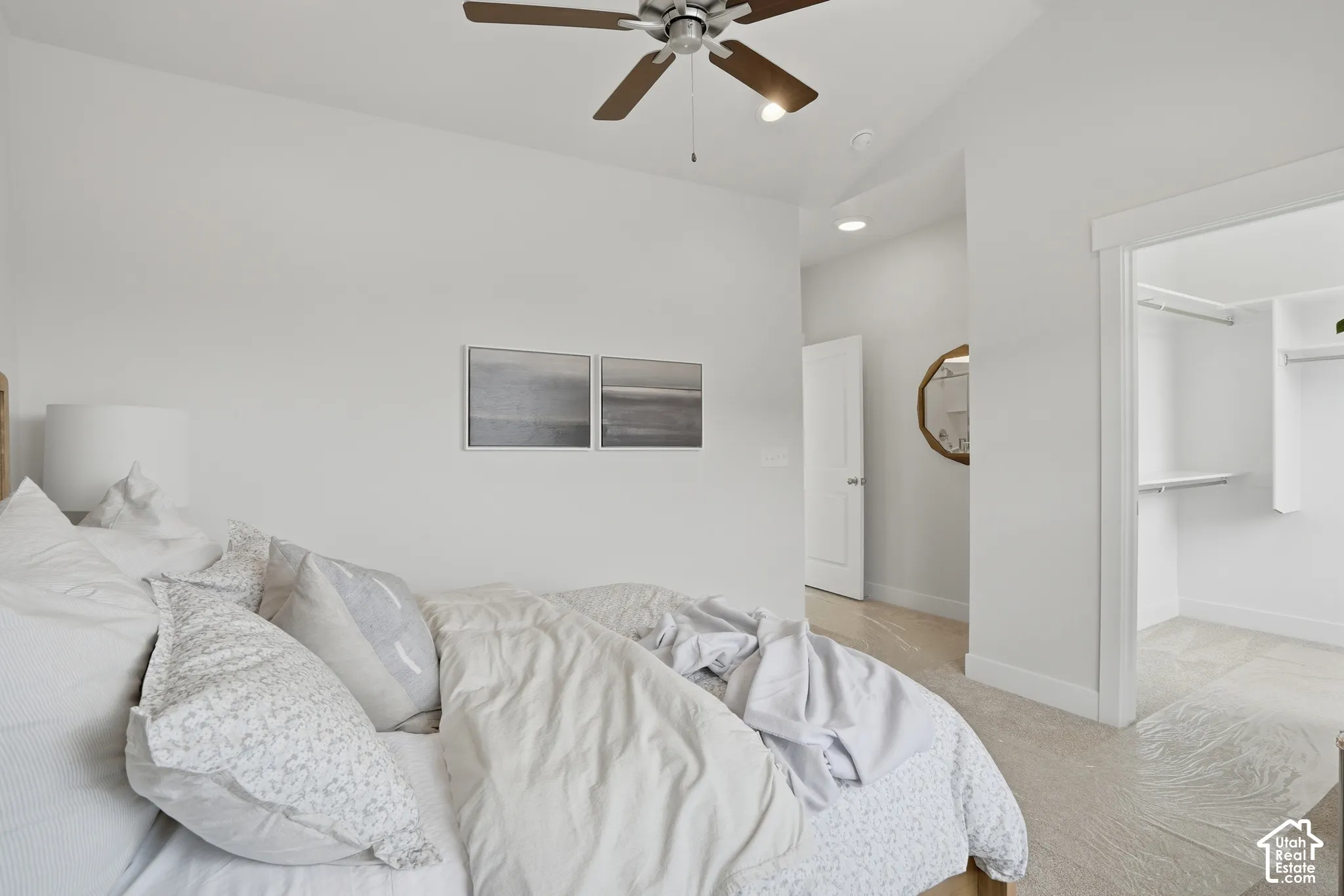Vaulted ceiling featuring a ceiling fan, recessed lighting, and a walk-in closet with built-in shelving
