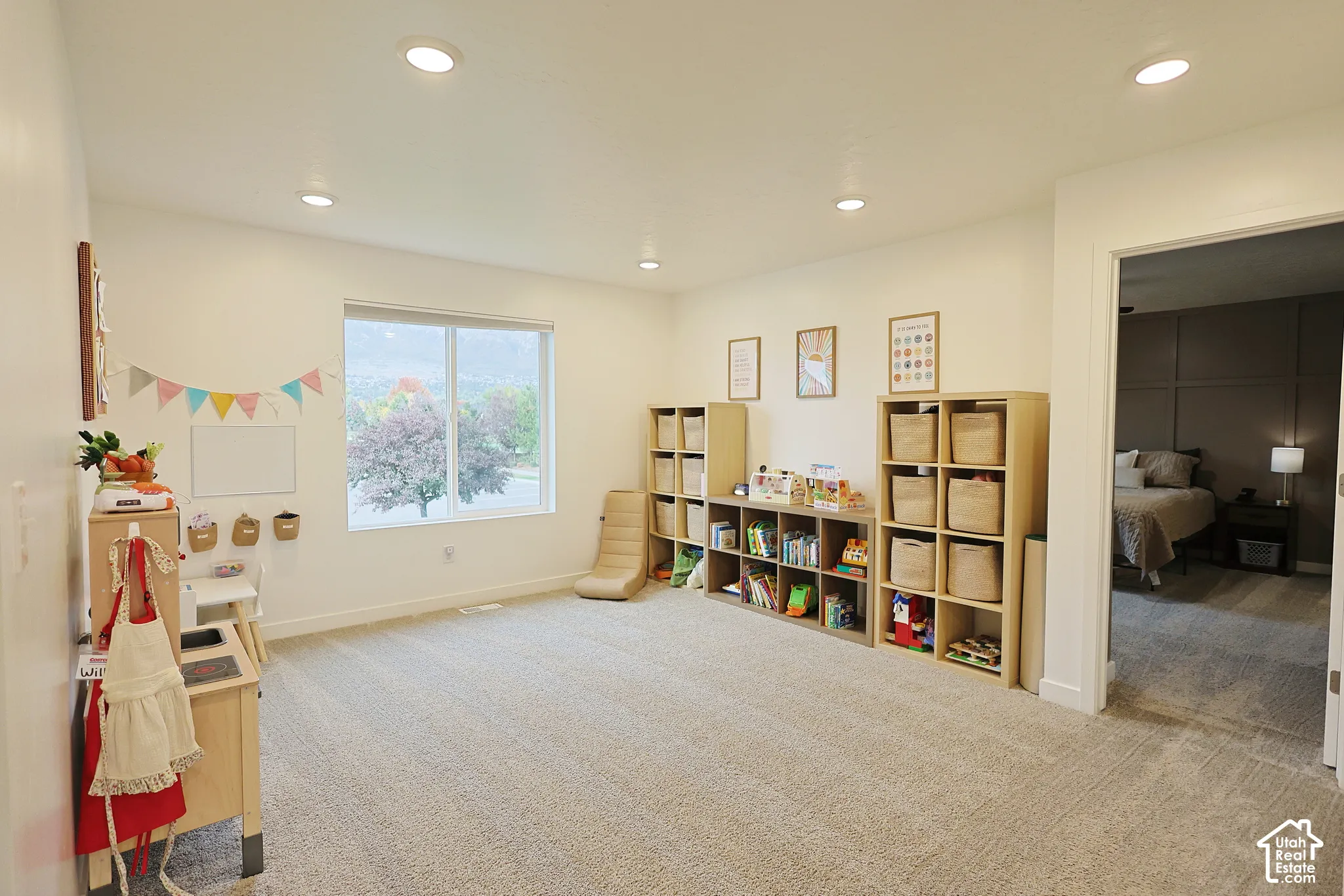 Neutral-toned carpet, recessed lighting, and large picture window