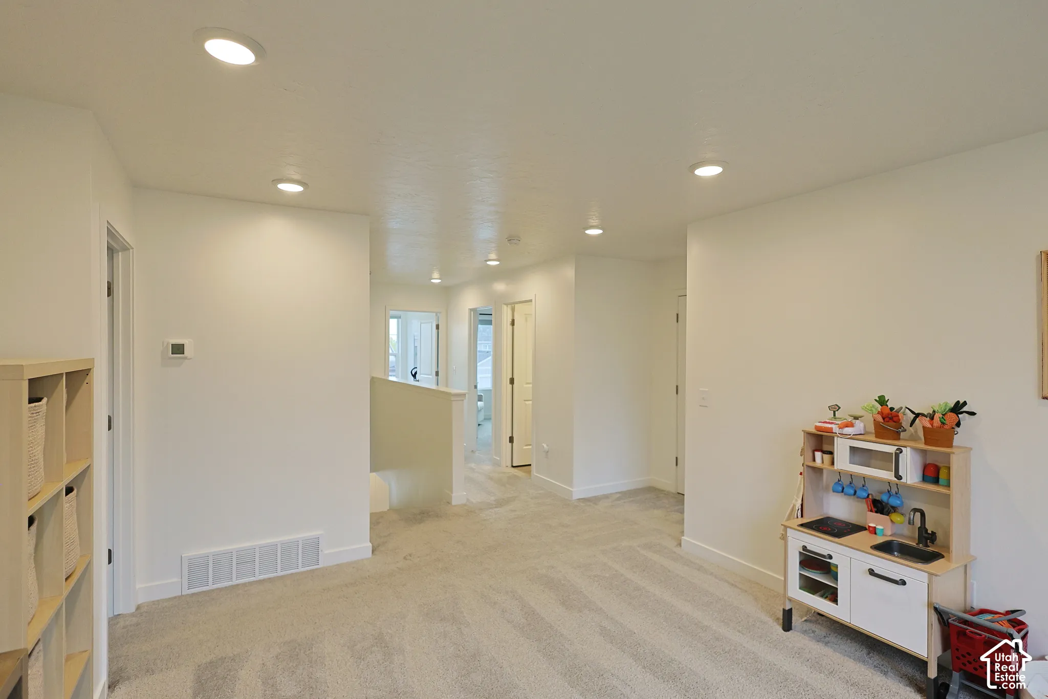 Interior space featuring recessed lighting, neutral wall finishes, and wall-to-wall carpeting