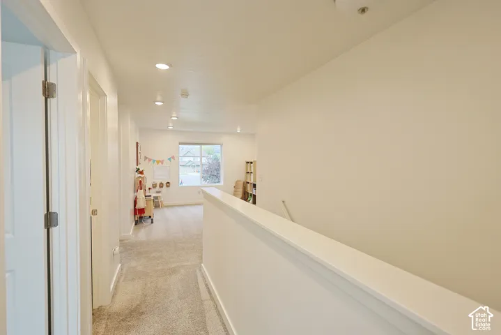 Neutral interior space featuring carpeting, recessed lighting, and a window with exterior exposure