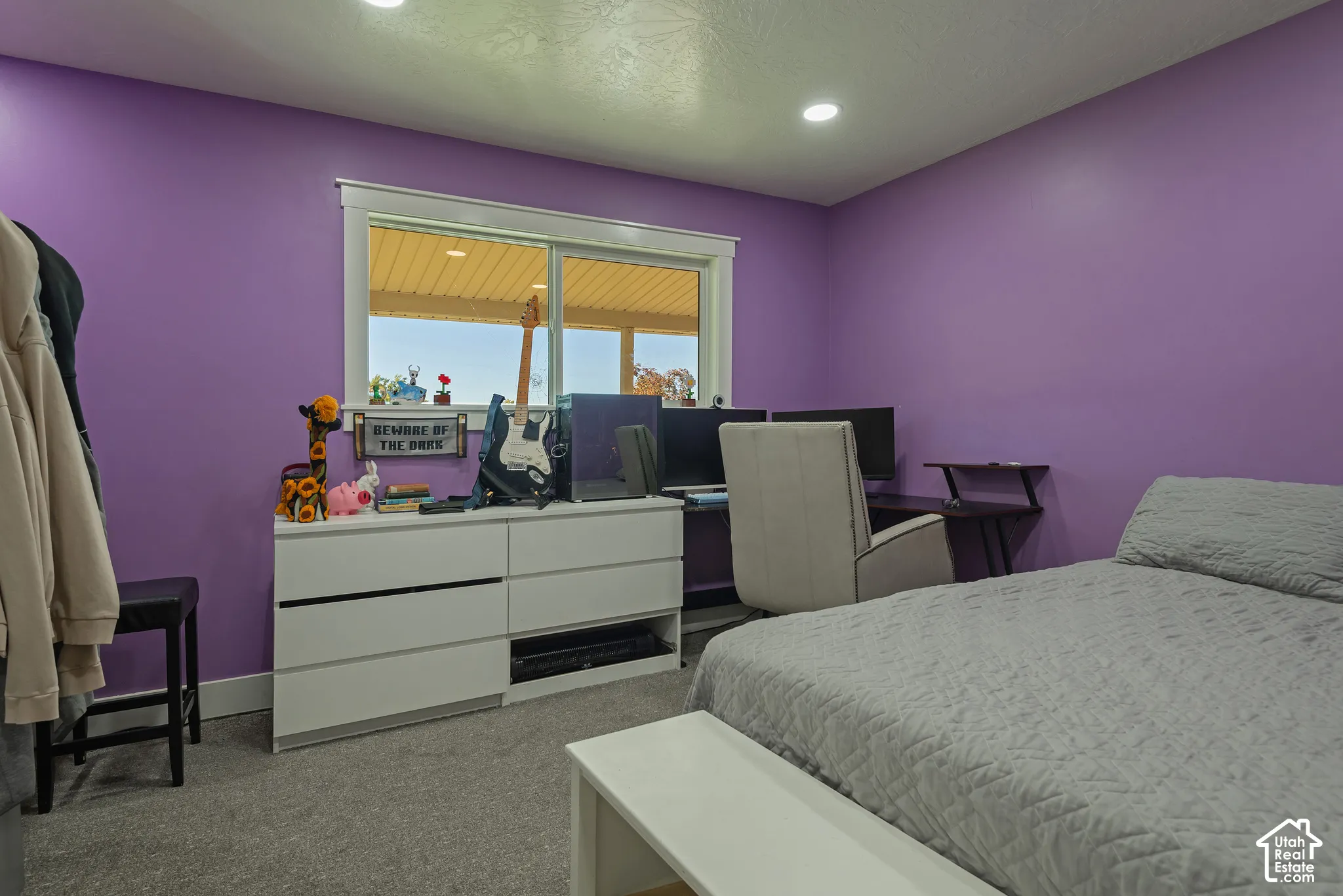 Room featuring neutral-toned carpeting, recessed lighting, and a window with white trim