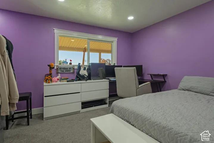 Room featuring neutral-toned carpeting, recessed lighting, and a window with white trim