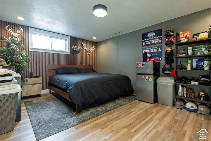 Wood-finish flooring, vertical slat wall treatment, and recessed ceiling lighting