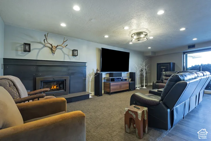 Fireplace featuring a modern black surround and hearth, recessed ceiling lighting, and hard-surface flooring