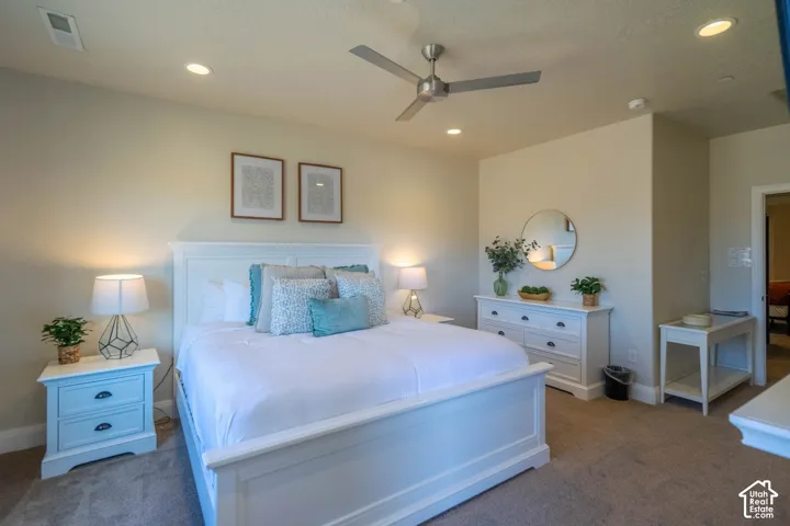 Room featuring recessed lighting, a neutral wall palette, plush wall-to-wall carpeting, and a brushed metal ceiling fan
