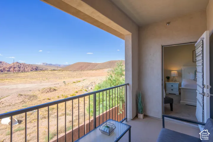 Covered balcony featuring metal railing and expansive desert and mountain scenery